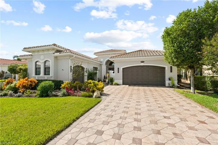 Mediterranean / spanish-style house featuring a garage and a front yard