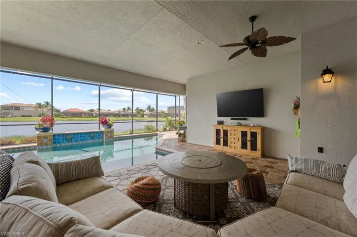 Living room featuring a textured ceiling and ceiling fan