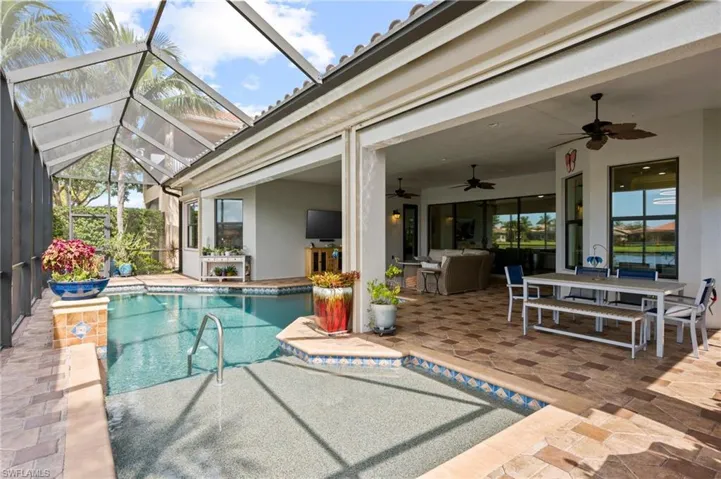 View of swimming pool featuring a lanai, ceiling fan, outdoor lounge area, and a patio area