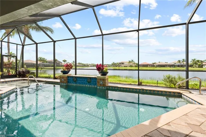 View of pool featuring a lanai, a patio, and a water view
