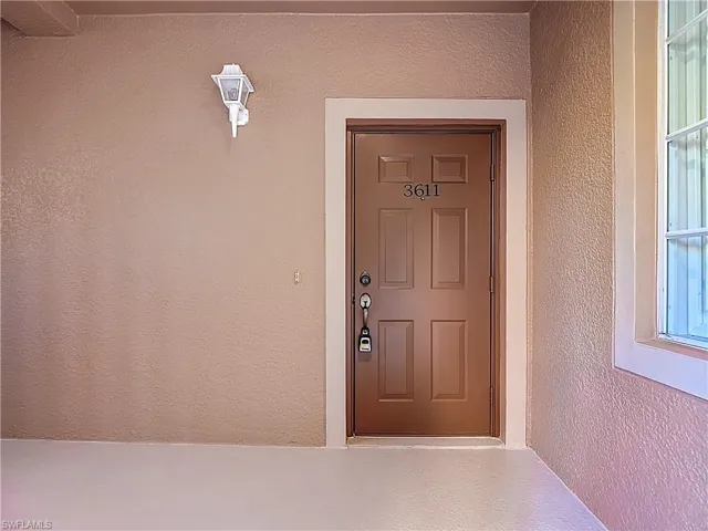 Entrance to property featuring stucco siding