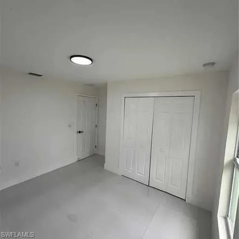 Unfurnished bedroom featuring a closet