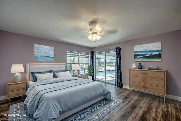 Bedroom with access to exterior, dark wood finished floors, and ceiling fan