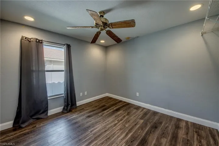 Spare room featuring a ceiling fan, dark wood-type flooring, and recessed lighting