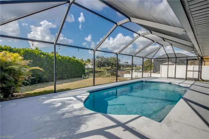 Outdoor pool with a sunroom, a lanai, and a patio area
