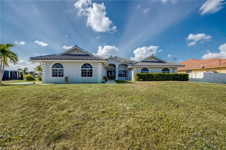 Mediterranean / spanish-style home featuring a tiled roof and stucco siding