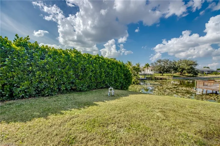 View of grassy yard with a water view