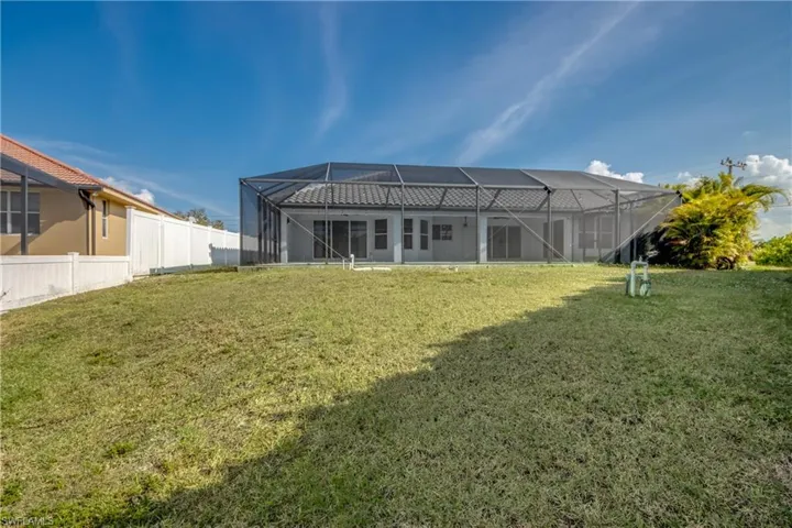 Back of house with a sunroom and a lanai