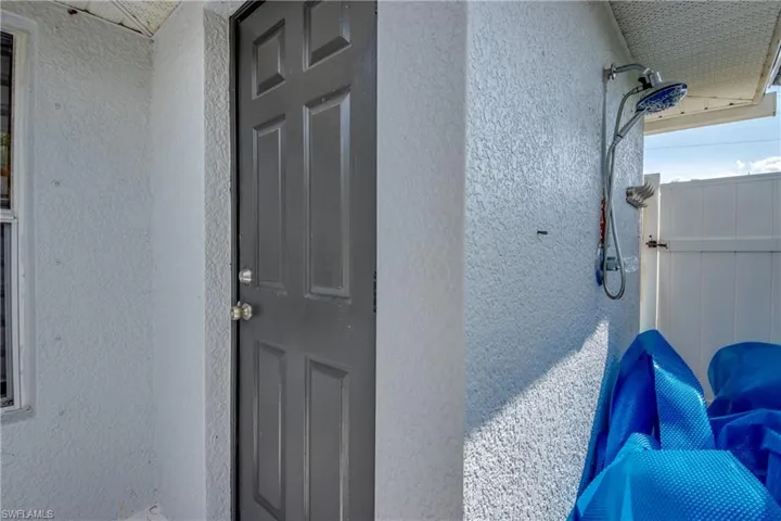 Entrance to property with stucco siding