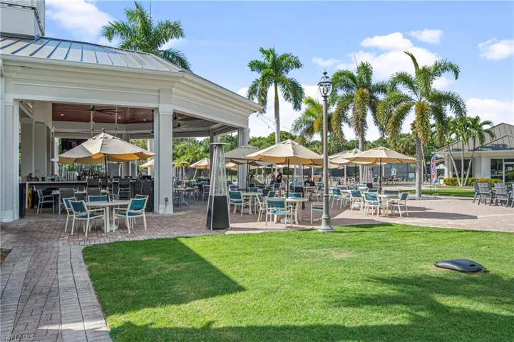 Surrounding community with a lawn and a patio area
