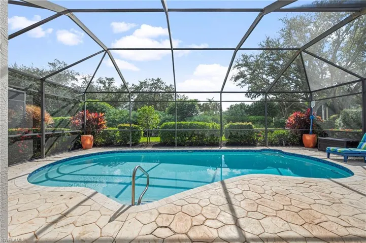 Outdoor pool featuring a sunroom, a lanai, and a patio area