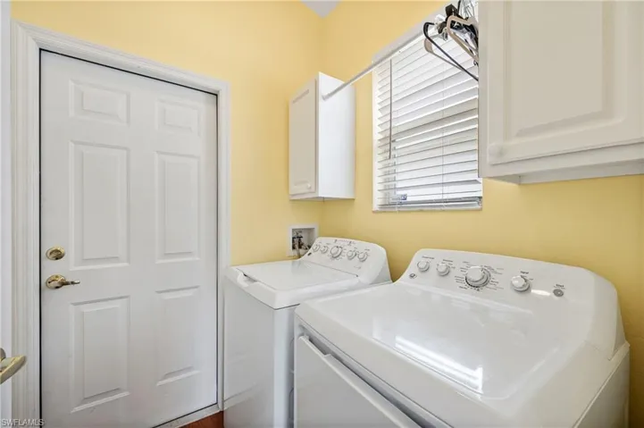 Washroom with cabinet space and washer and dryer