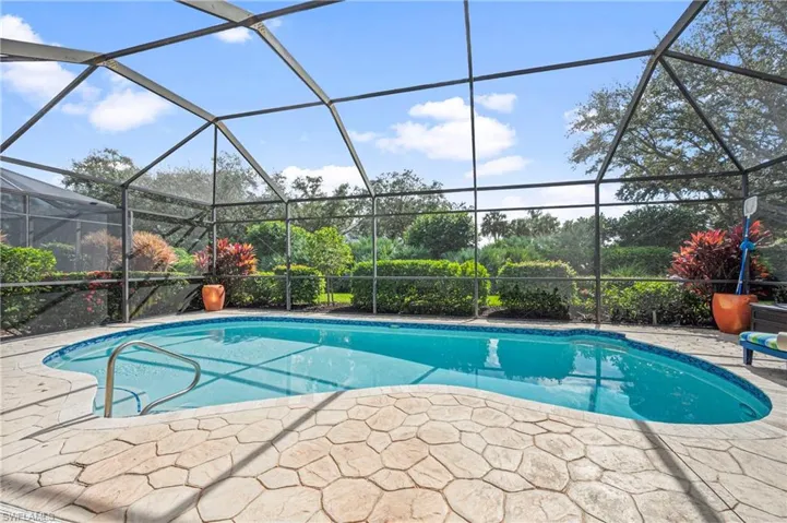 Outdoor pool featuring a sunroom and glass enclosure