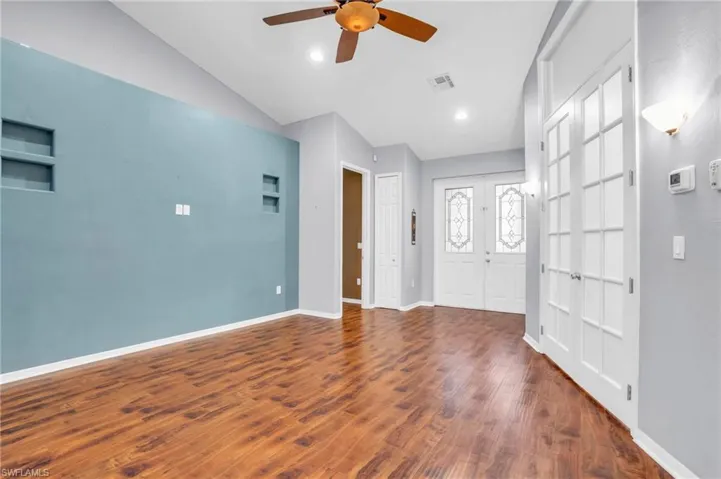 Formal Living room featuring wood-type flooring, lofted ceiling, and ceiling fan
