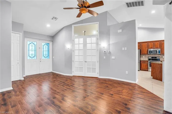 Entrance foyer with french doors, vaulted ceiling, ceiling fan with view of the office