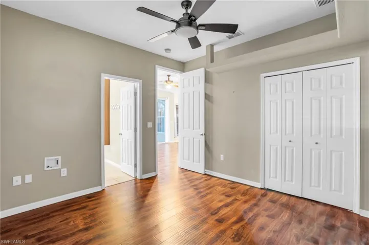 Guest bedroom #3 featuring ensuite bathroom, ceiling fan and vinyl flooring