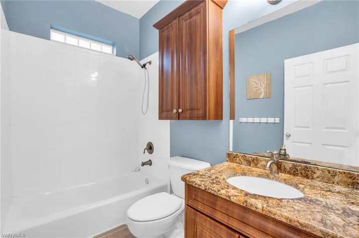 Guest bathroom with vanity and shower/tub combination