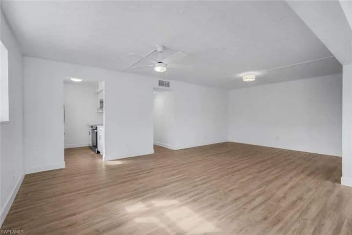 View of living room and kitchen from dining area.