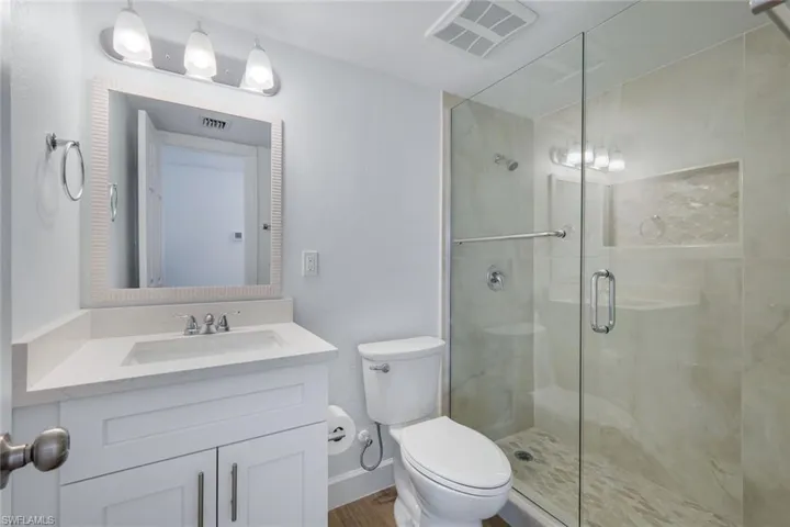 Guest bathroom offers walk-in shower.