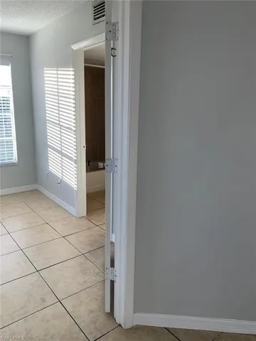 Spare room featuring light tile patterned floors and a textured ceiling