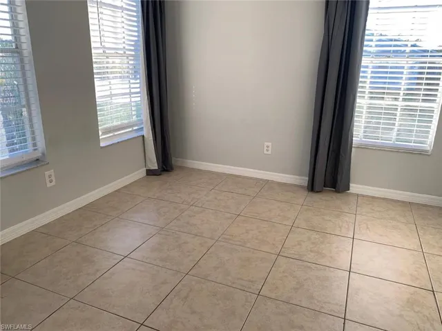 Empty room with light tile patterned floors