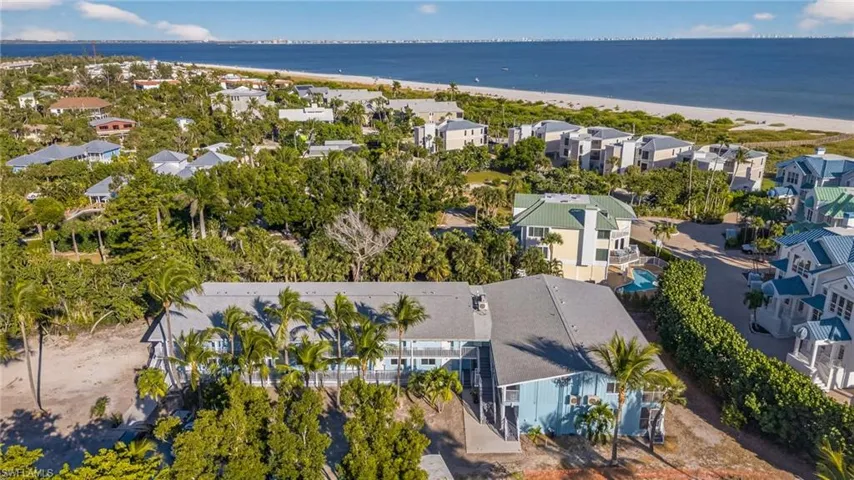 Aerial perspective of suburban area with waterfront with a beach