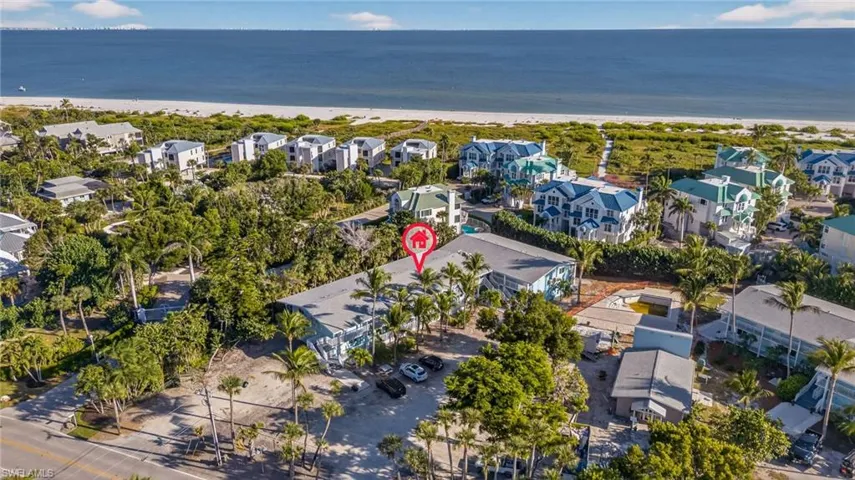 Aerial overview of property's location featuring extended coastline
