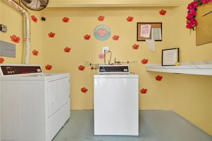 Shared laundry room featuring washer and clothes dryer