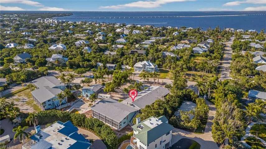 Aerial perspective of suburban area featuring a large body of water