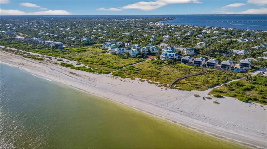 Aerial perspective of suburban area featuring expansive beach