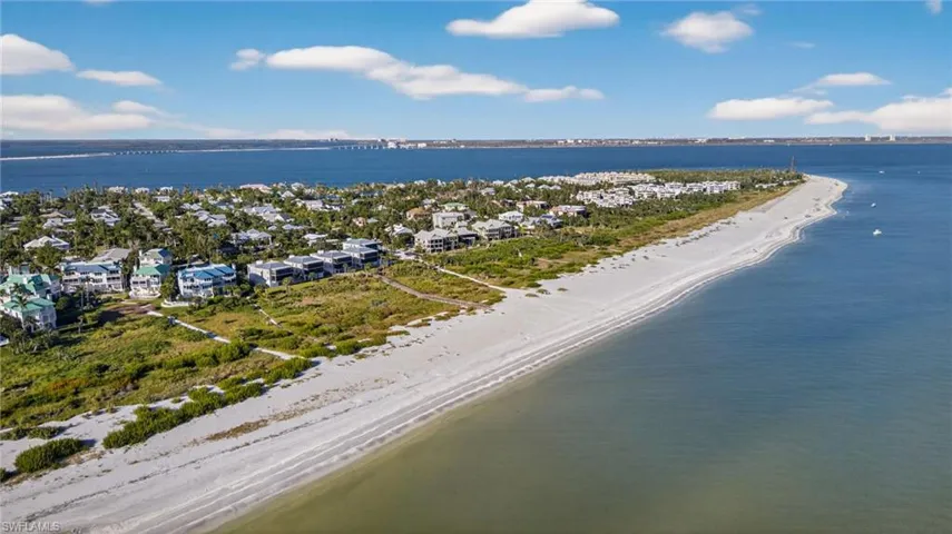 Aerial perspective of suburban area featuring waterfront with a beach