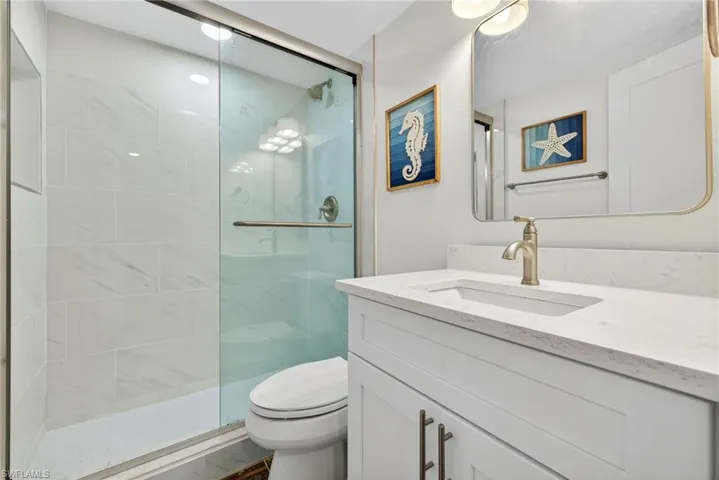 Full bathroom featuring vanity and a shower stall