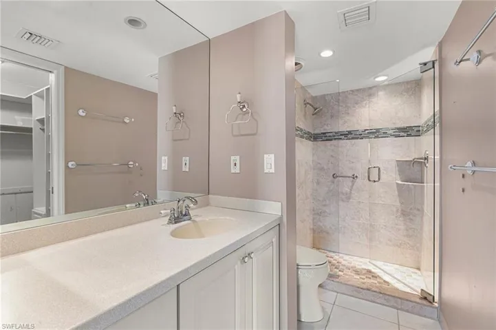 Updated Guest Bathroom with Pressed glass accent in stand alone shower