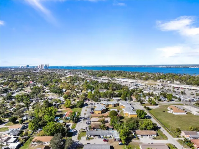 Birds eye view of property with a water view