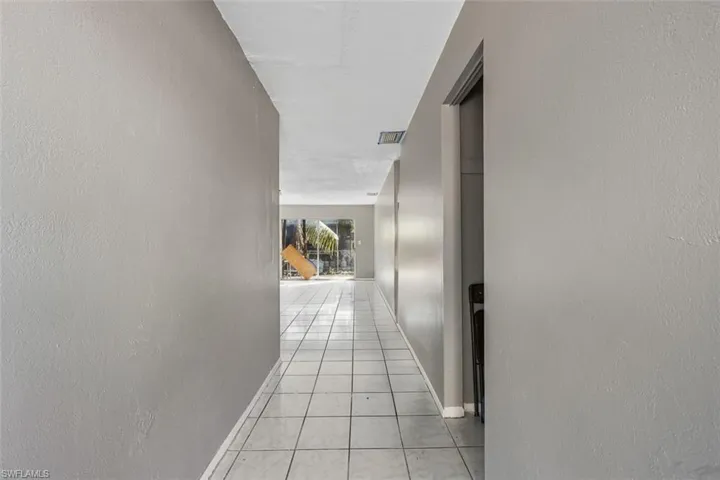 Hallway with light tile patterned flooring