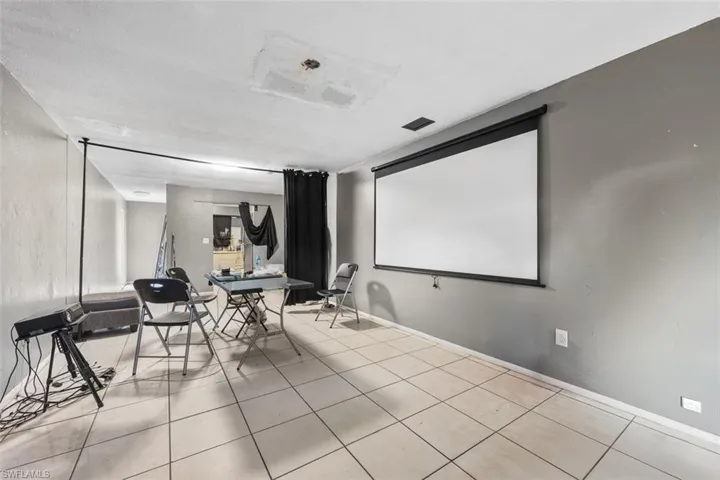 Cinema room with light tile patterned floors