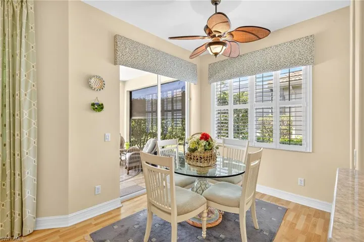 Primary bedroom features a tray ceiling and plantation shutters.