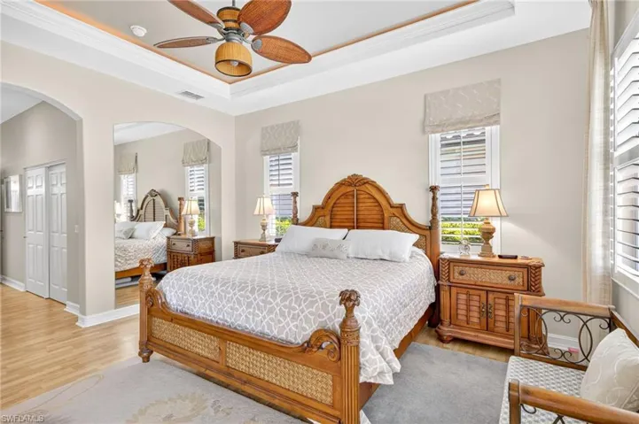 Primary bedroom offers lanai access and beautiful outdoor views.
