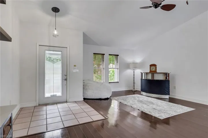 Entrance foyer featuring dark wood-style floors and a ceiling fan
