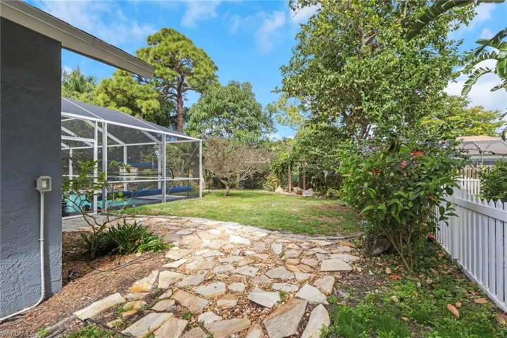 Fenced backyard featuring glass enclosure, a sunroom, a patio, and a pool