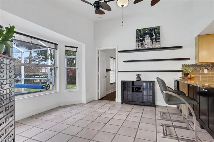 Dining area featuring a ceiling fan and light tile patterned floors