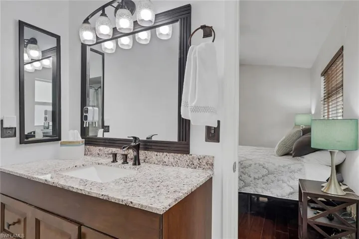 Ensuite bathroom with vanity and dark wood finished floors