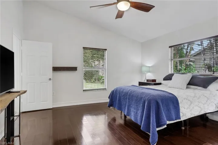 Bedroom featuring lofted ceiling, ceiling fan, and dark wood finished floors
