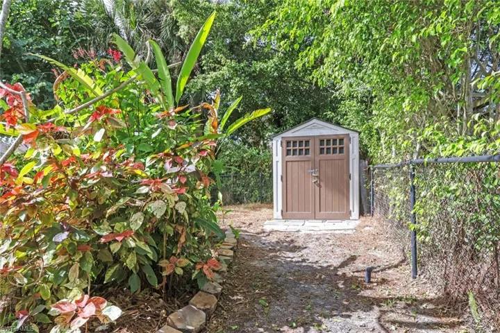 View of shed with a fenced backyard