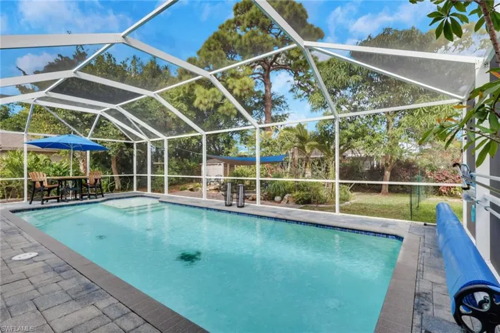 Outdoor pool featuring a lanai, a sunroom, and a patio