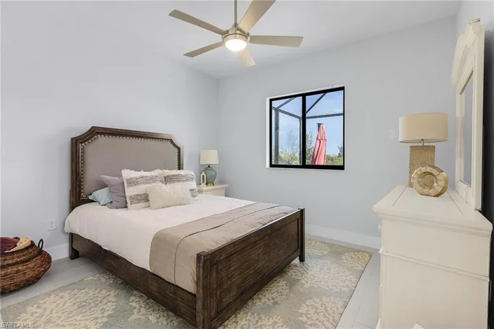 Bedroom with ceiling fan and light hardwood / wood-style flooring