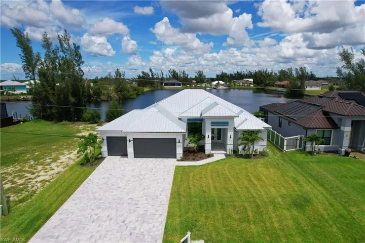 Modern farmhouse style home with a porch, a water view, a garage, and a front yard