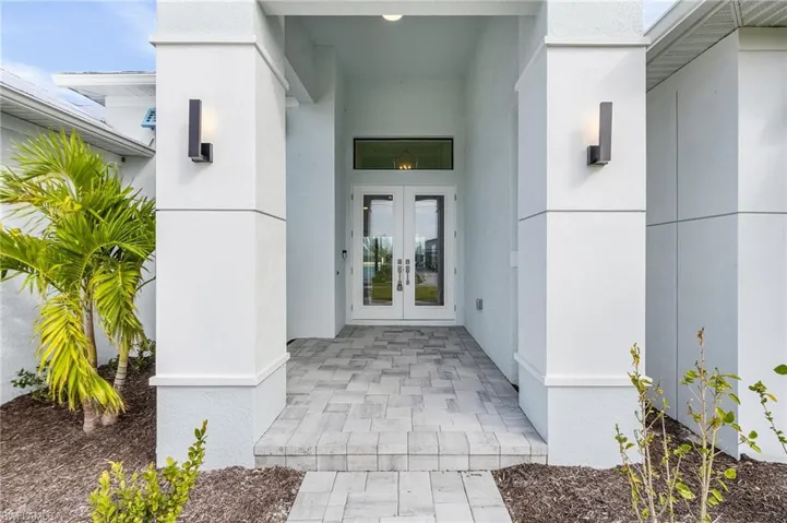 Property entrance featuring french doors
