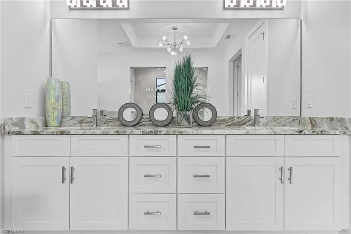 Tiled bedroom with ensuite bathroom and ceiling fan