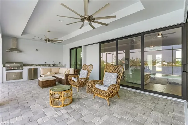 View of patio / terrace with an outdoor living space, exterior kitchen, area for grilling, and ceiling fan